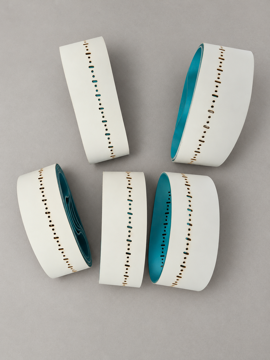 Perforated textile aprons with white outer and turquoise inner surfaces